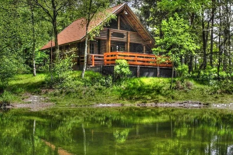 Romantic log house on a small idyllic forest lake