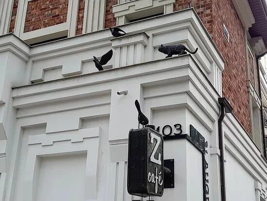 Cat Chasing Pigeons Sculpture