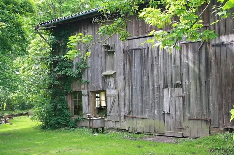 Real wooden barn with a dining area under trees