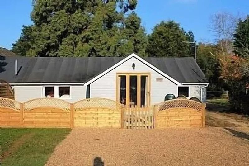 Luxury Single Storey Wooden Clad Colonial Style Cottage In Countryside Setting.
