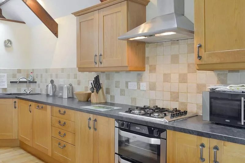 A semi-detached barn conversion set in a sheltered valley with sheep and cows