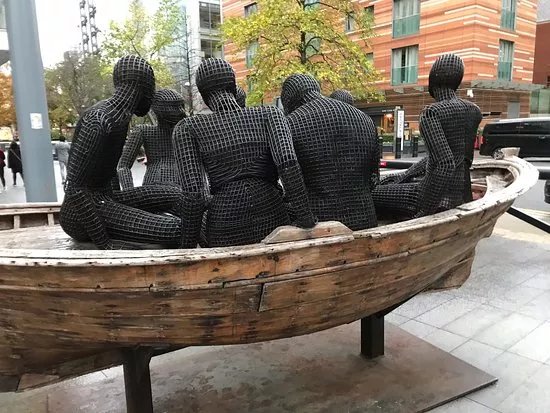 Wooden Boat with Seven People Sculpture