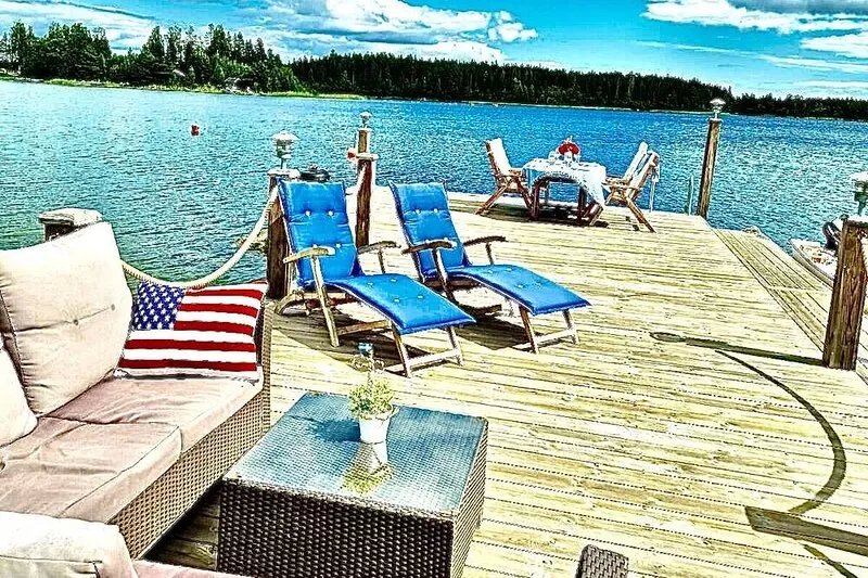 Log house with private beach and own dock incl. boat