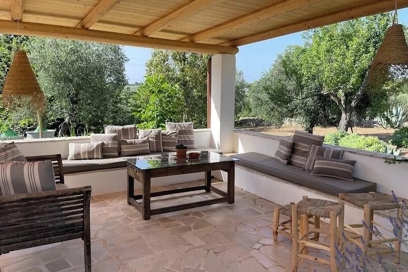 An ancient Trullo surrounded by olive trees with a gorgeous saltwater pool