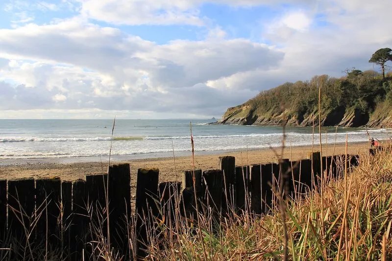 Turreted gatehouse to the historic Caerhays Castle located on the beach on the