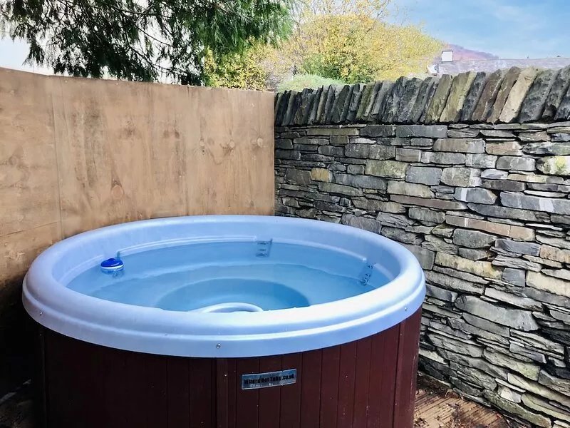 Lake District village apartment with private riverside hot tub