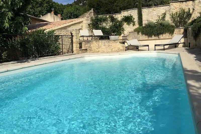Eighteenth-century stone farmhouse with swimming pool at the top of a historic