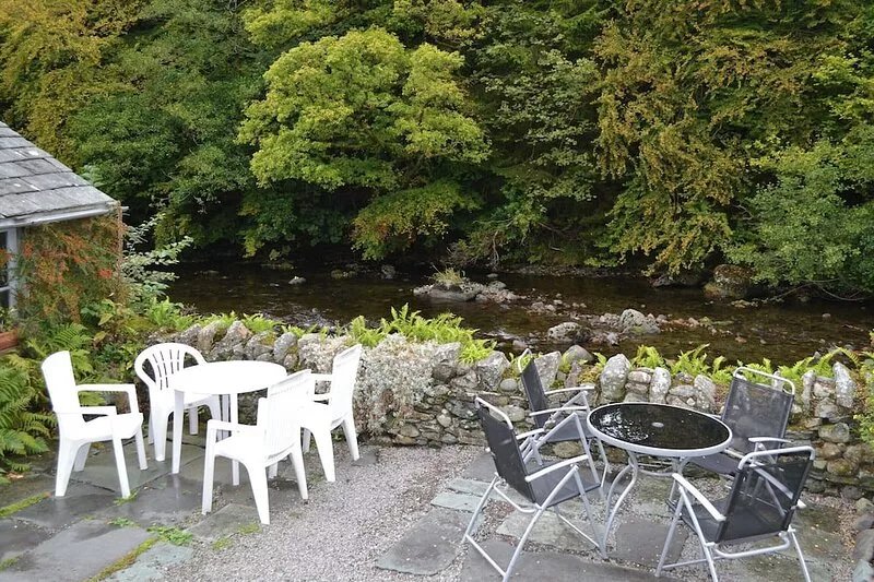A traditional Lakeland stone terraced cottage ideally situated on the banks of