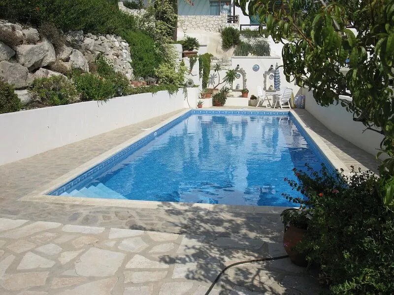 A hillside retreat with a large pool and set in extensive gardens