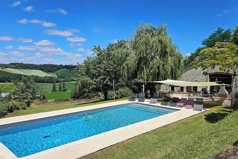 Spacious, beautifully converted barn with exposed wooden beams, swimming pool