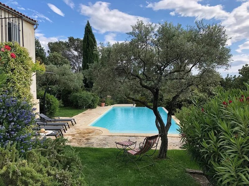 Villa with outdoor kitchen with pizza oven and large heated pool.