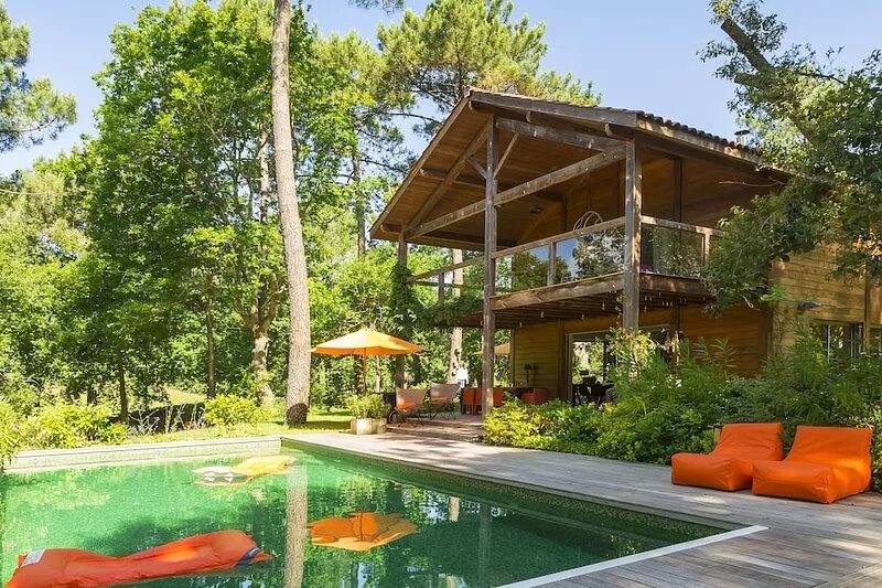 Modern wooden villa on large lot with heated pool located in the Golf of