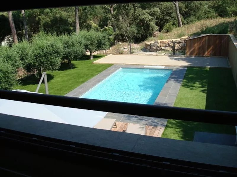 new villa with heated pool under umbrella pines and olive trees.