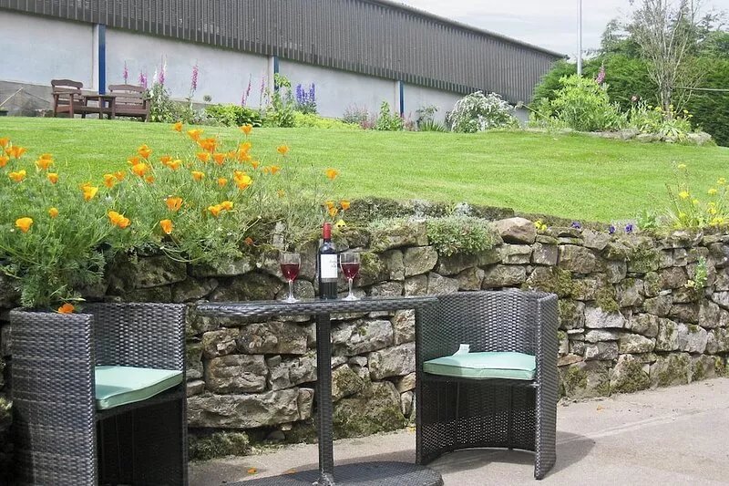 A restored barn with open fire situated on a working farm with views over