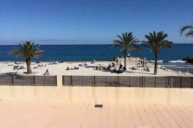 Feet in the water, the view of the beach and the sea