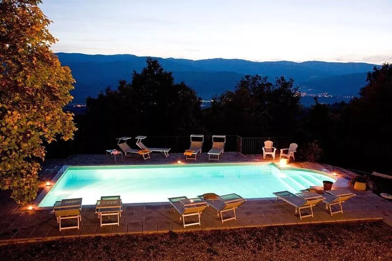 Ancient country villa with pool in the hills of Tuscany, surrounded by woods