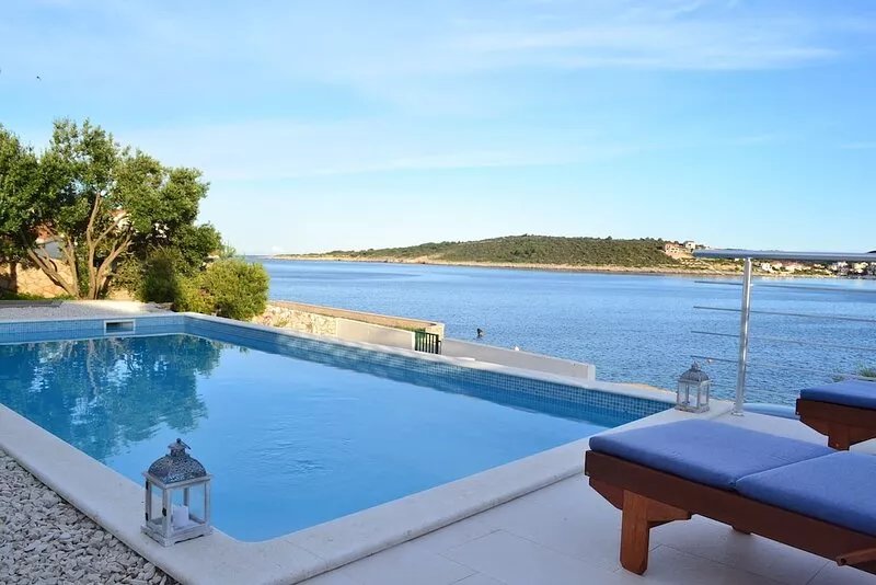 Holiday beach house with private heated pool  and buoy