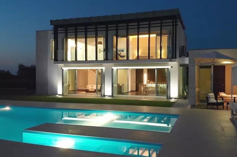 Modern villa with swimming pool surrounded by greenery