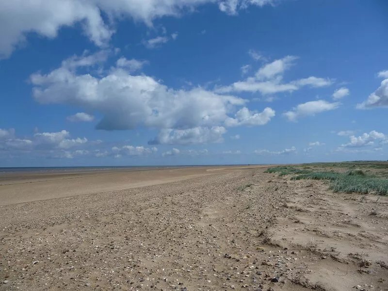 Brick and flint pet friendly cottage a short walk to sandy beach and pub