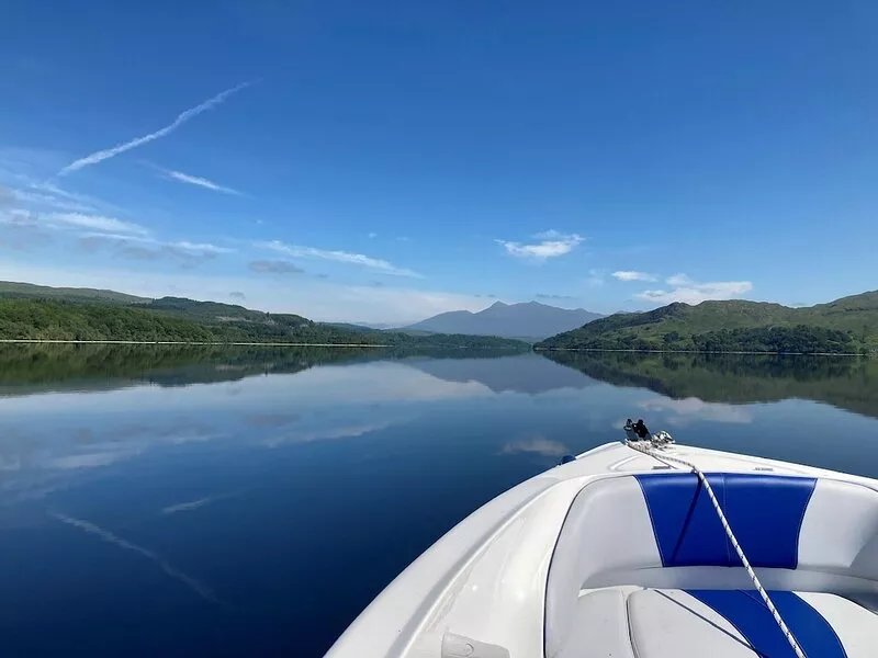 Charming loch side log cabin with hot tub & stunning views across loch