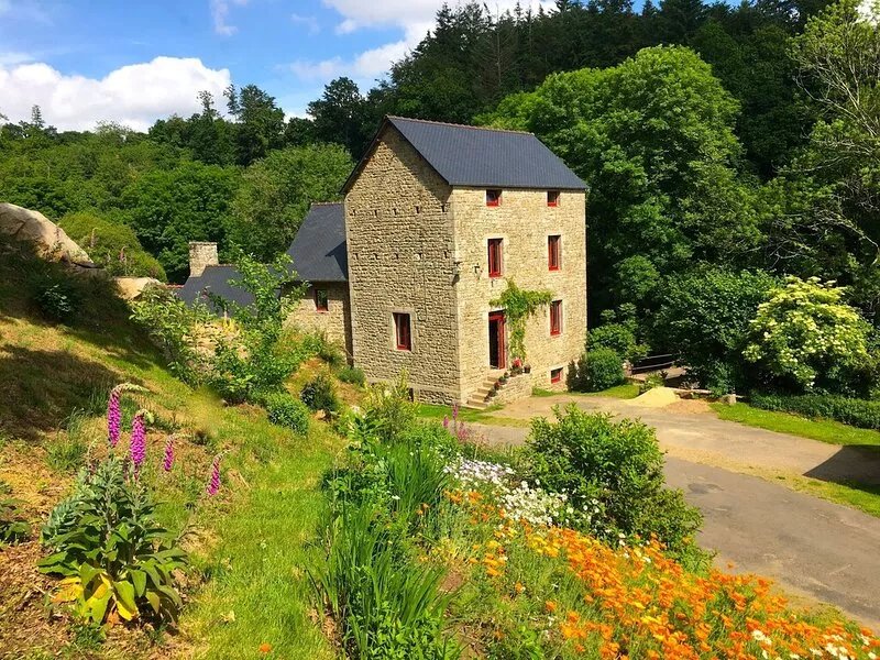 Authentic mill with feet in water (near the sea)