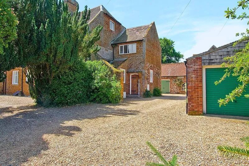 A spacious apartment once part of the old vicarage in the pretty village of Old