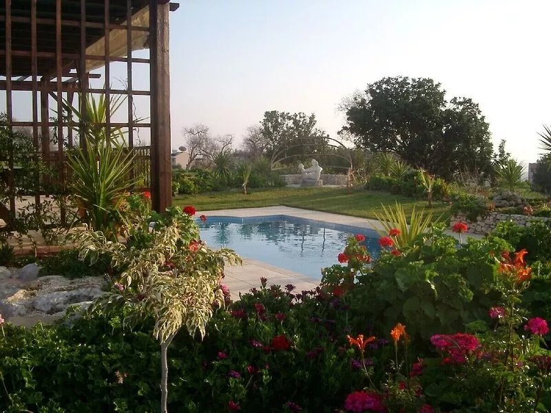 A charming villa set in beautiful gardens with panoramic sea views.