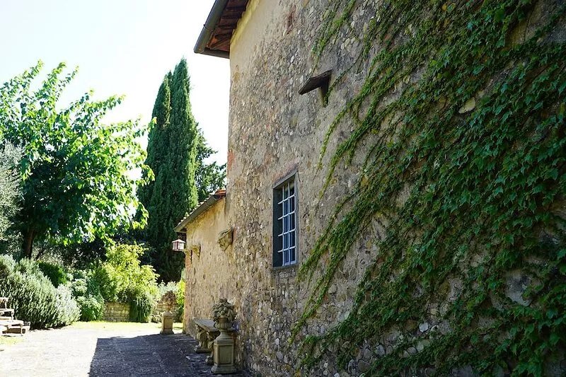 Tuscan house on vineyard hilltop tucked inside lush gardens
