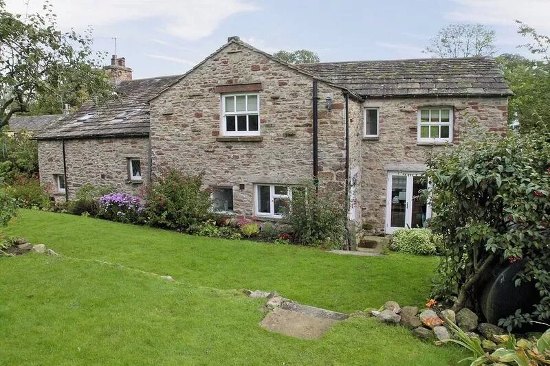 A spacious detached cottage located by a beck in a quiet village.