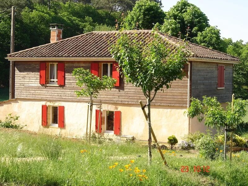 House in the countryside, with large expanses of woods and fields.