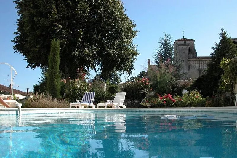 Character house, air-conditioned, heated pool, fenced garden with trees.