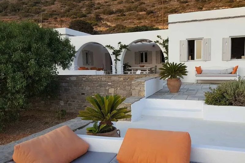 Cycladic house between olive trees and Aegean sea, magnificent sea view