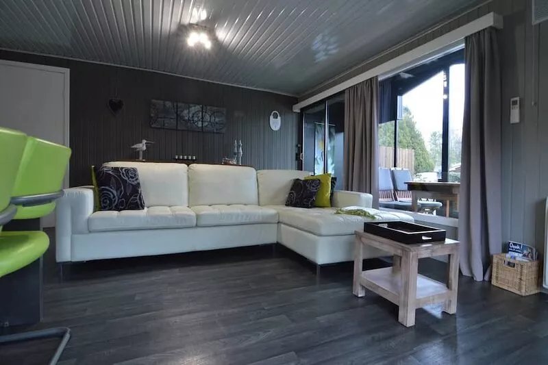 Modern chalet in a small park with a fishing pond