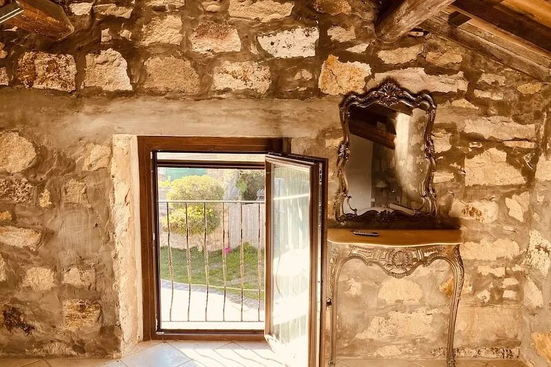 Villa with garden, large windows, exposed beams and stones