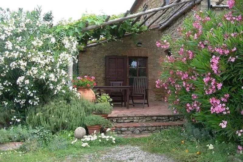 Farmhouse from 17th century with antique furniture and many flowers.