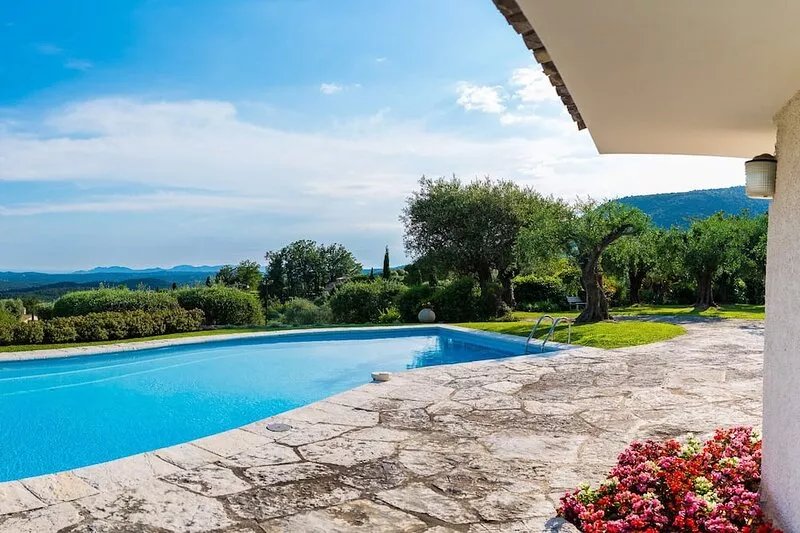 Modern villa in park swimming pool and floodlit tennis court