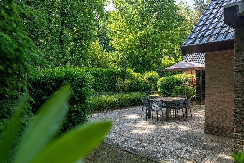Beautiful house with a fireplace in a holiday park in the woods